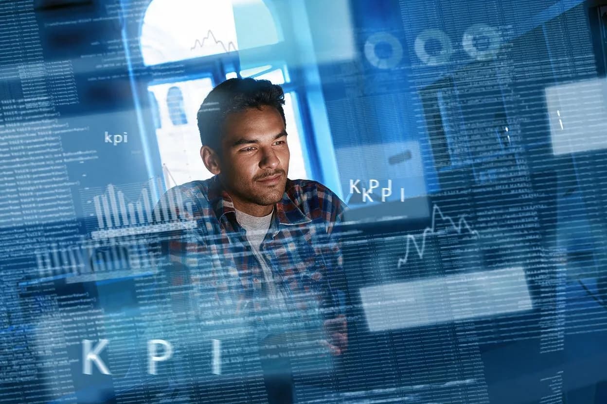 Analyst reviewing KPI dashboards on transparent screens
